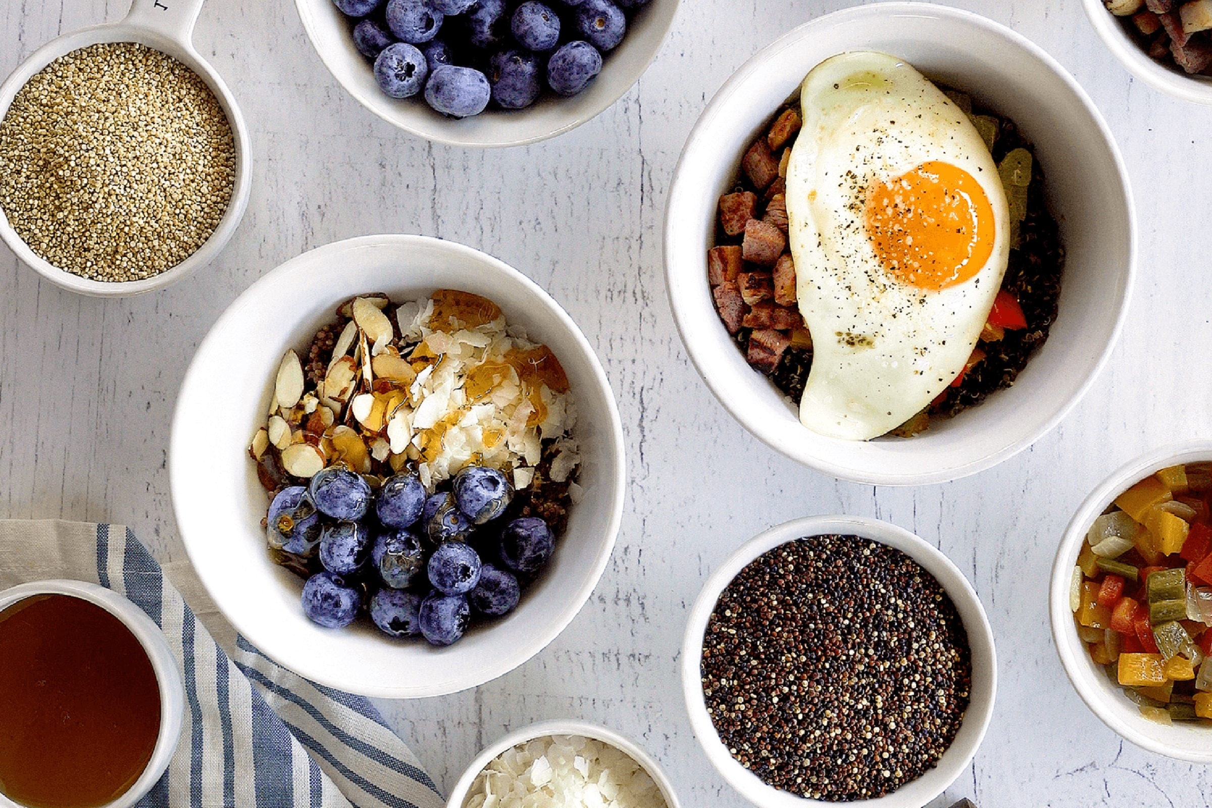 Lundberg Organic Antique White and Tri-Color Blend Quinoa are shown with sweet and savory breakfast bowls.
